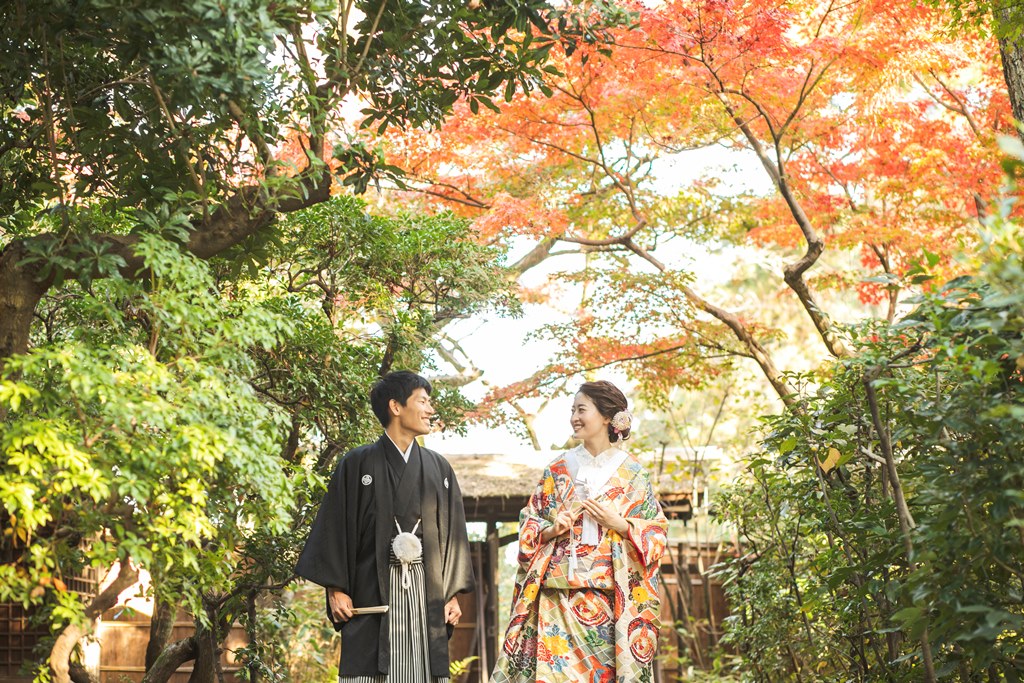 綺麗な紅葉の下で向き合っている夫婦